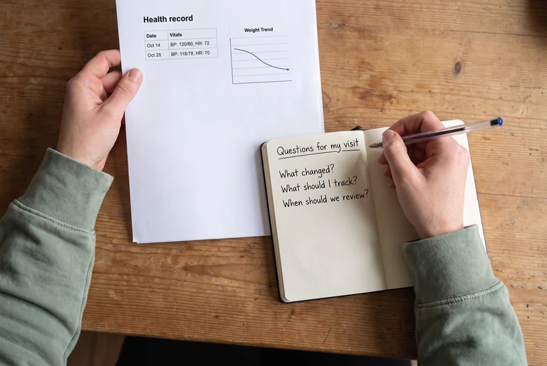 Health reports and notes organized in a folder on a consultation-room desk